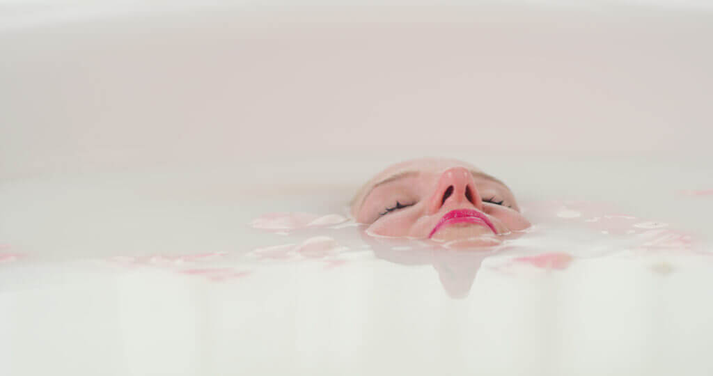 woman submerged in milk bath