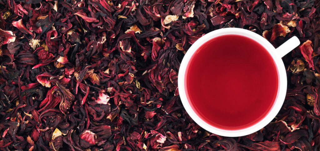 Cup of hibiscus tea on the leaves