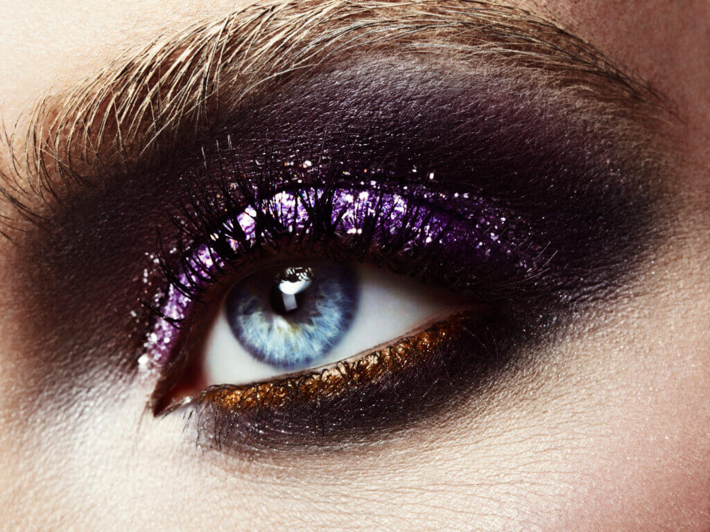 Female eye with professional bright shiny make-up.