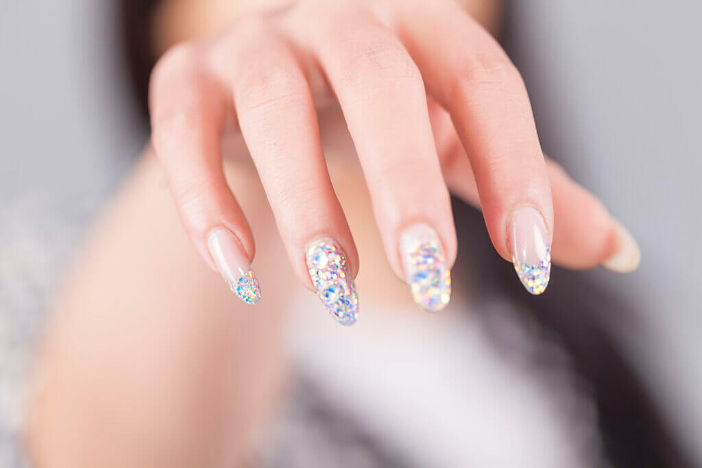 Young girl showing polished nails