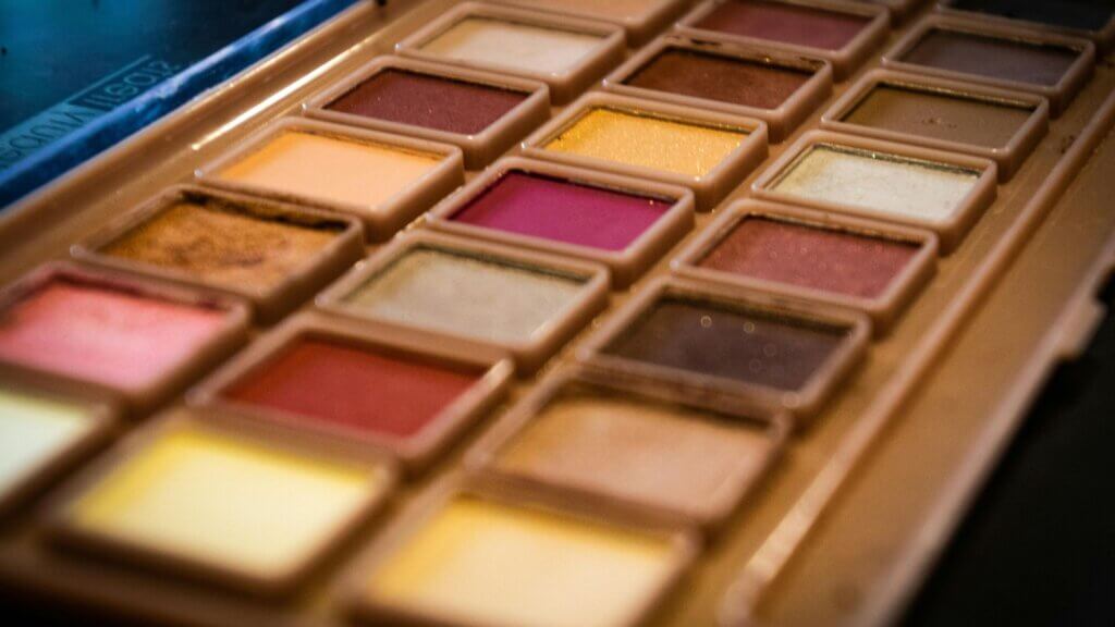 Soft-focus photo of a makeup palette with warm tones