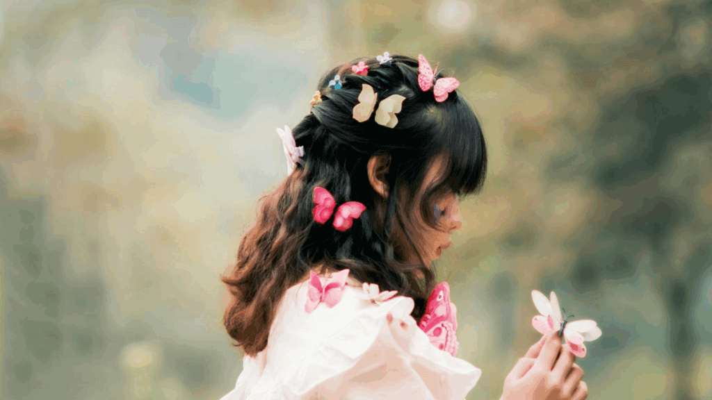 Woman with multiple butterfly clips in her hair, shot from behind