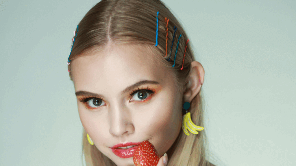 Woman wearing fruit-themed accessories, including a large banana hair clip