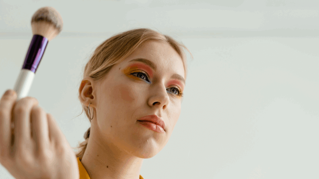 Woman holding a makeup brush near her eye