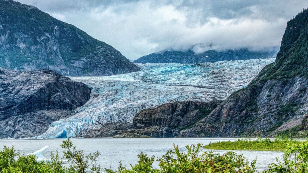 The Mendenhall Glacier in Juneau, Alaska surrounded by majestic mountains
