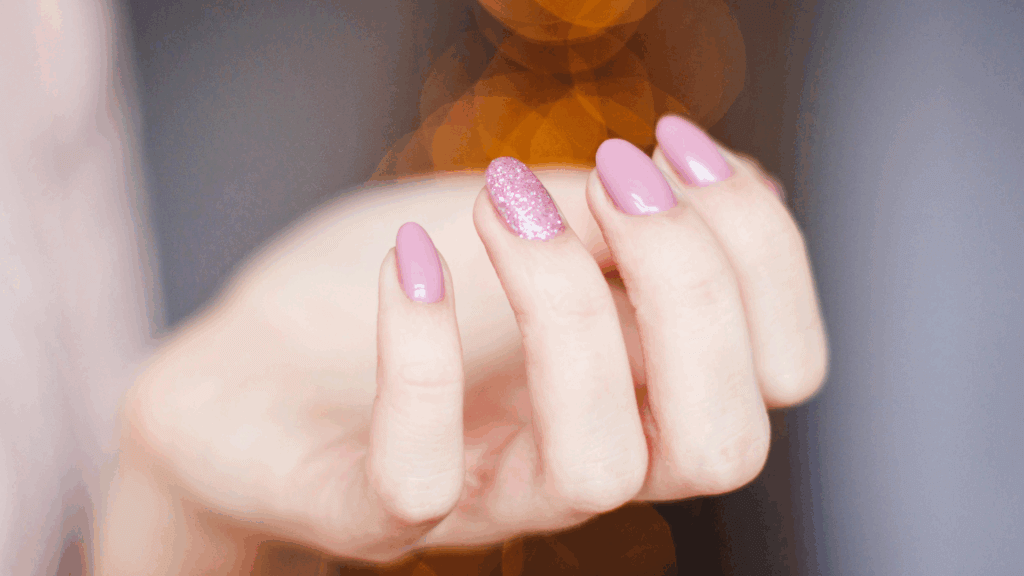 Close-up of pink manicure on woman’s nails