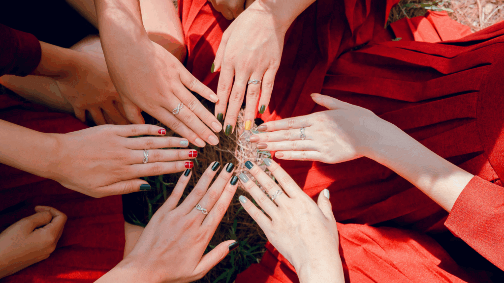 Women’s hands resting together with natural manicures