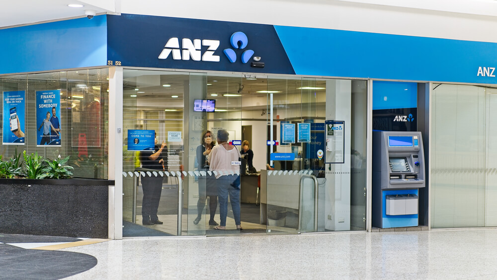 SEVEN HILLS, NSW / AUSTRALIA - MARCH 27, 2020: Seven Hills Plaza shopping centre ANZ bank with customer entering and speaking with staff with masks during Covid-19 pandemic