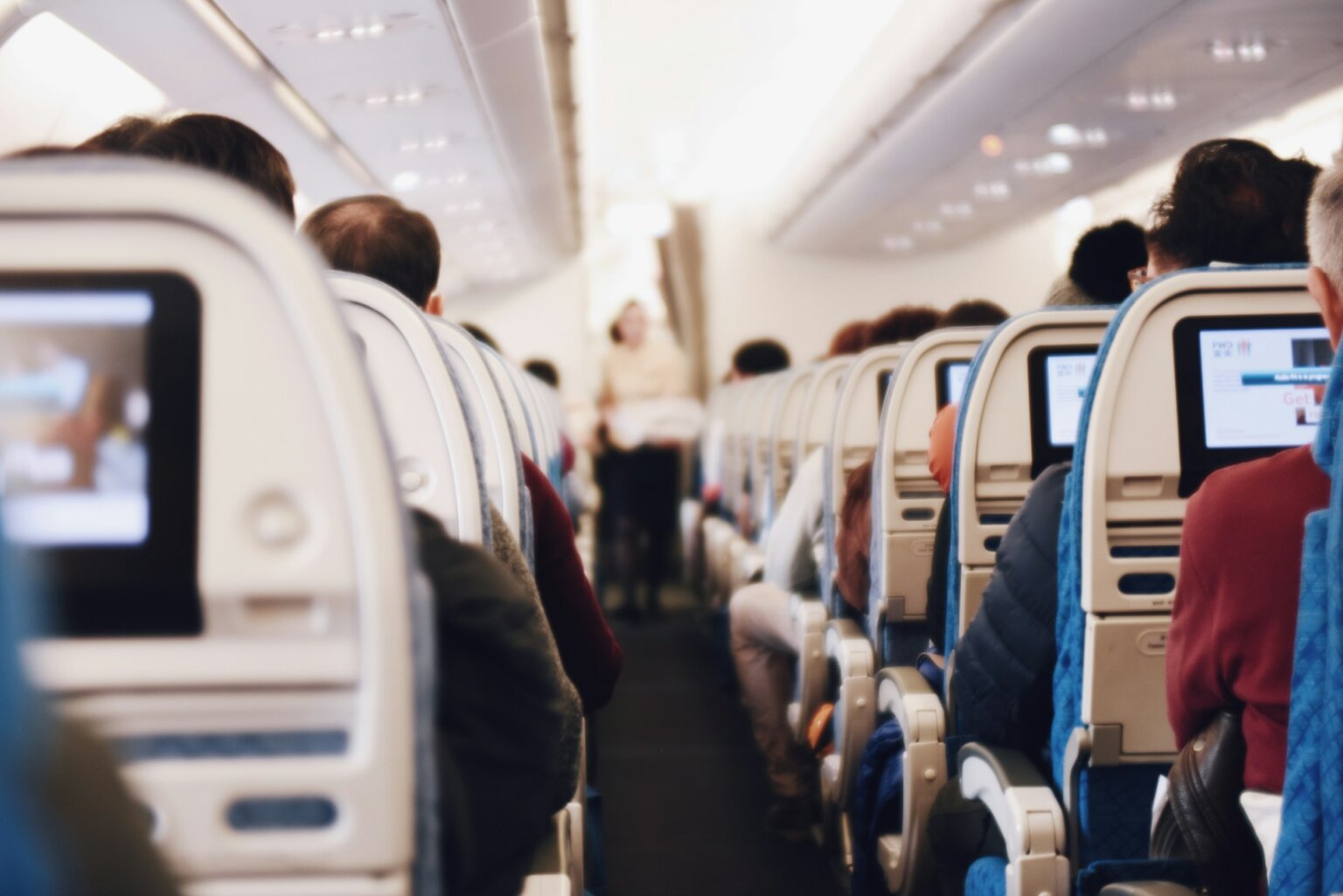 People sitting on an airplane facing forward