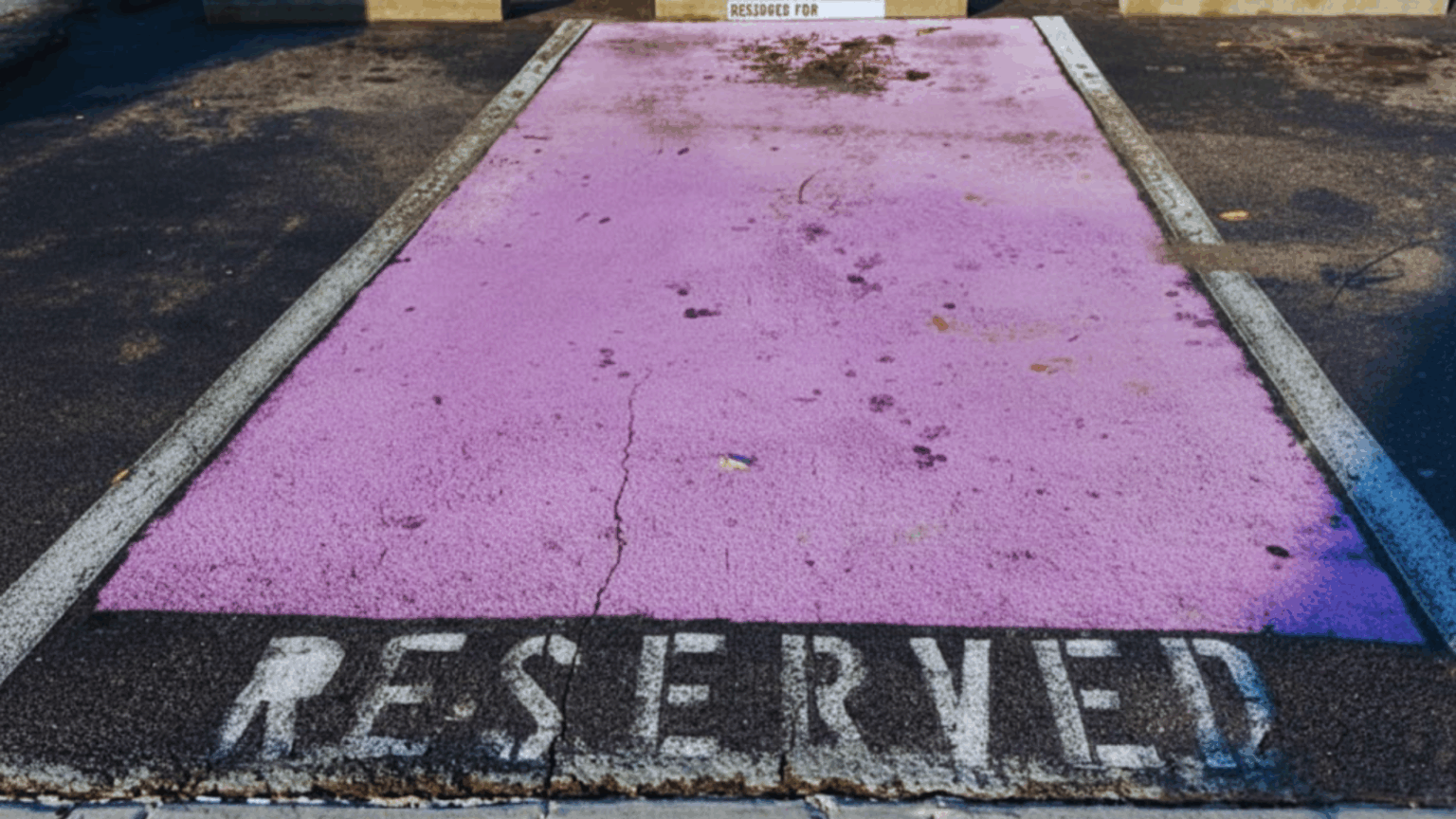 Purple parking spot with the words reserved underneath