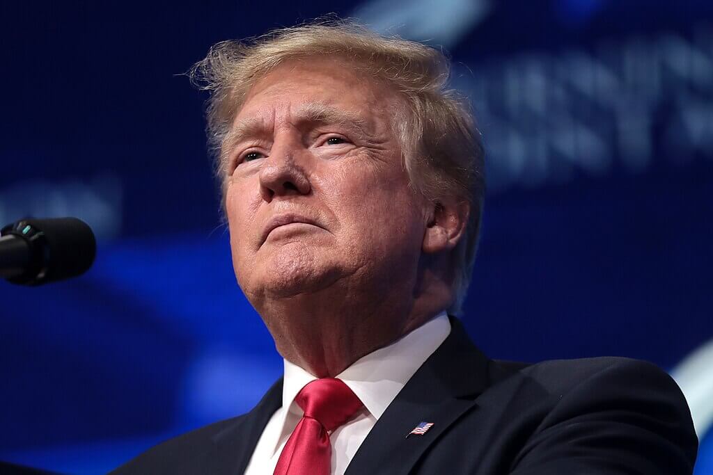 Donald Trump speaking at a podium during a public event.