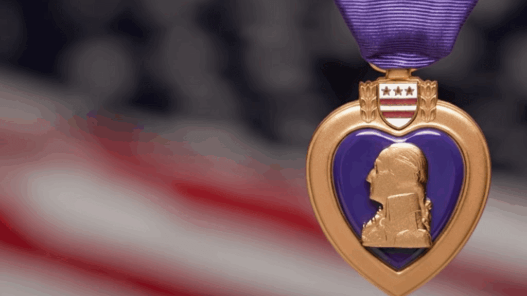 A purple heart medal with an American flag behind it