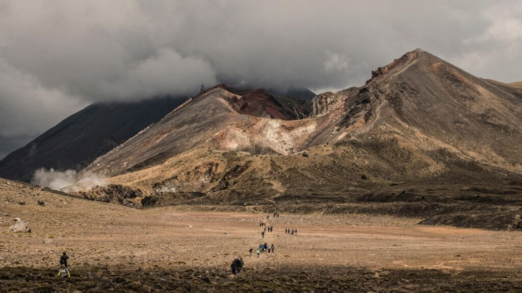 People at the base of a volcano