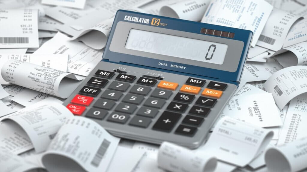 A calculator in a pile of receipts