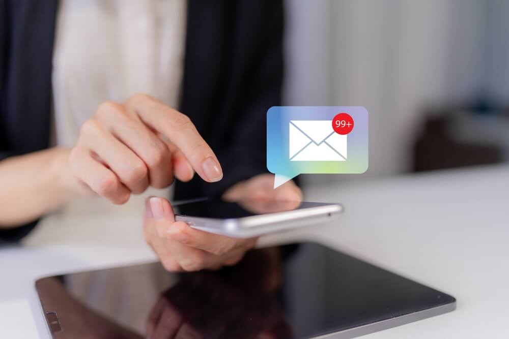 Image of person on their phone clicking into their Email
