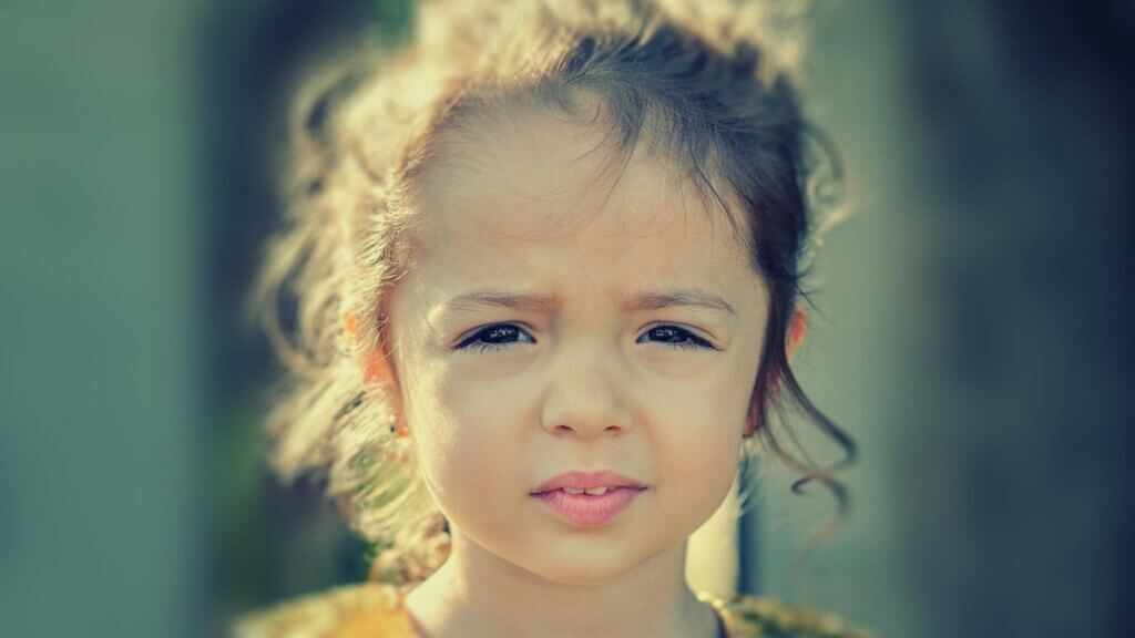 A small girl looking straight forward