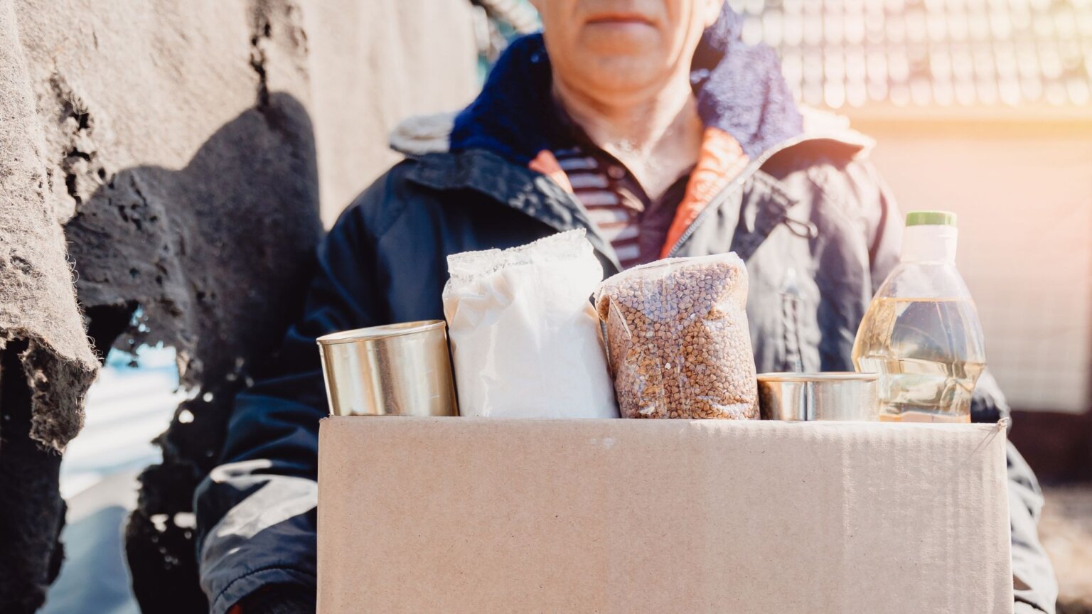 Ex-Goodwill Employee Says They Got Written Up for Giving Blanket to Homeless Person in Winter A person in need holding a bin of donated food