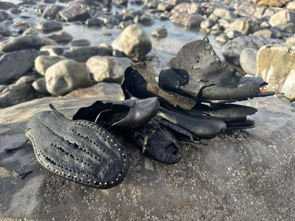 Leather shoes washed up on beach
