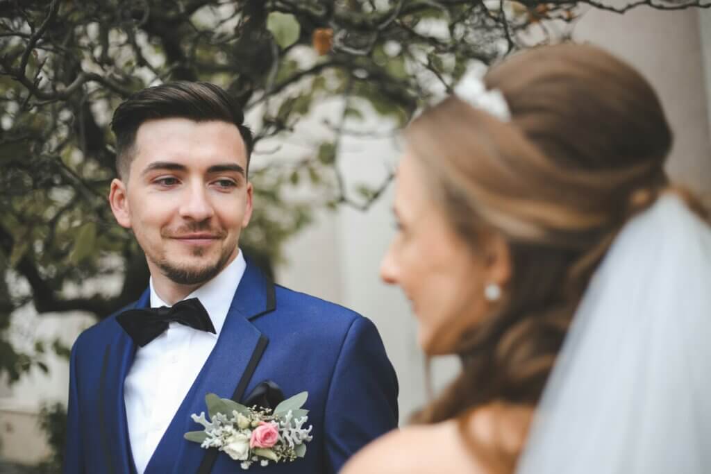 Groom looking lovingly at his bride