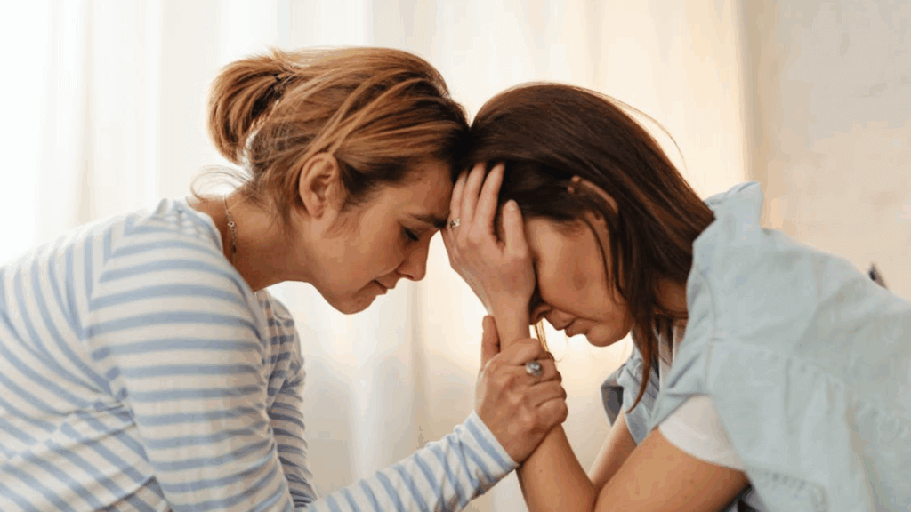 Child holding parent while crying