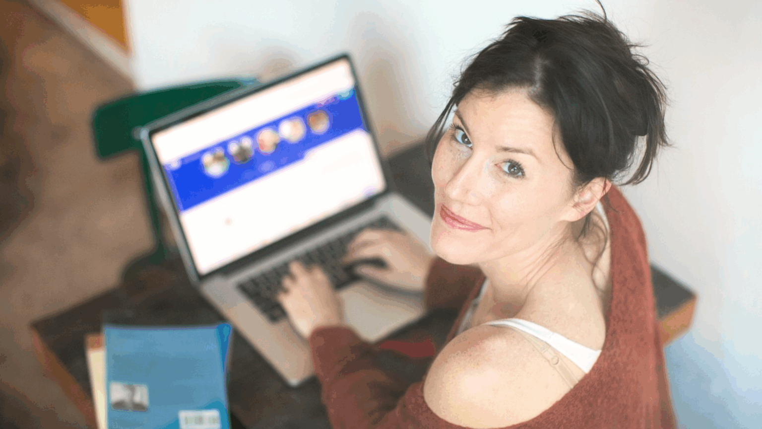 woman looking back while using the laptop
