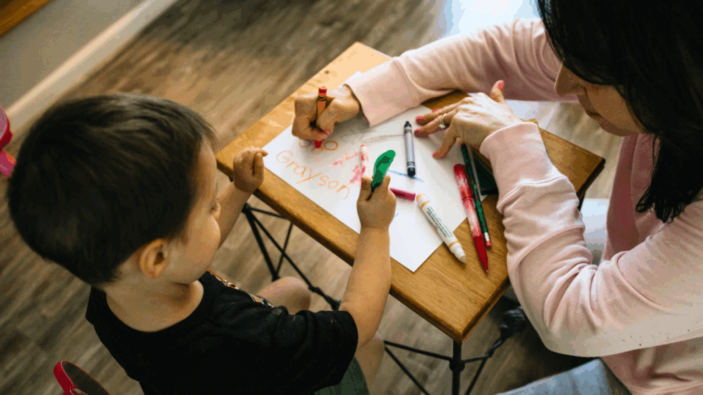 woman teaching a kid how to write