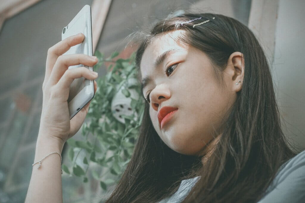 Young woman looking at her phone