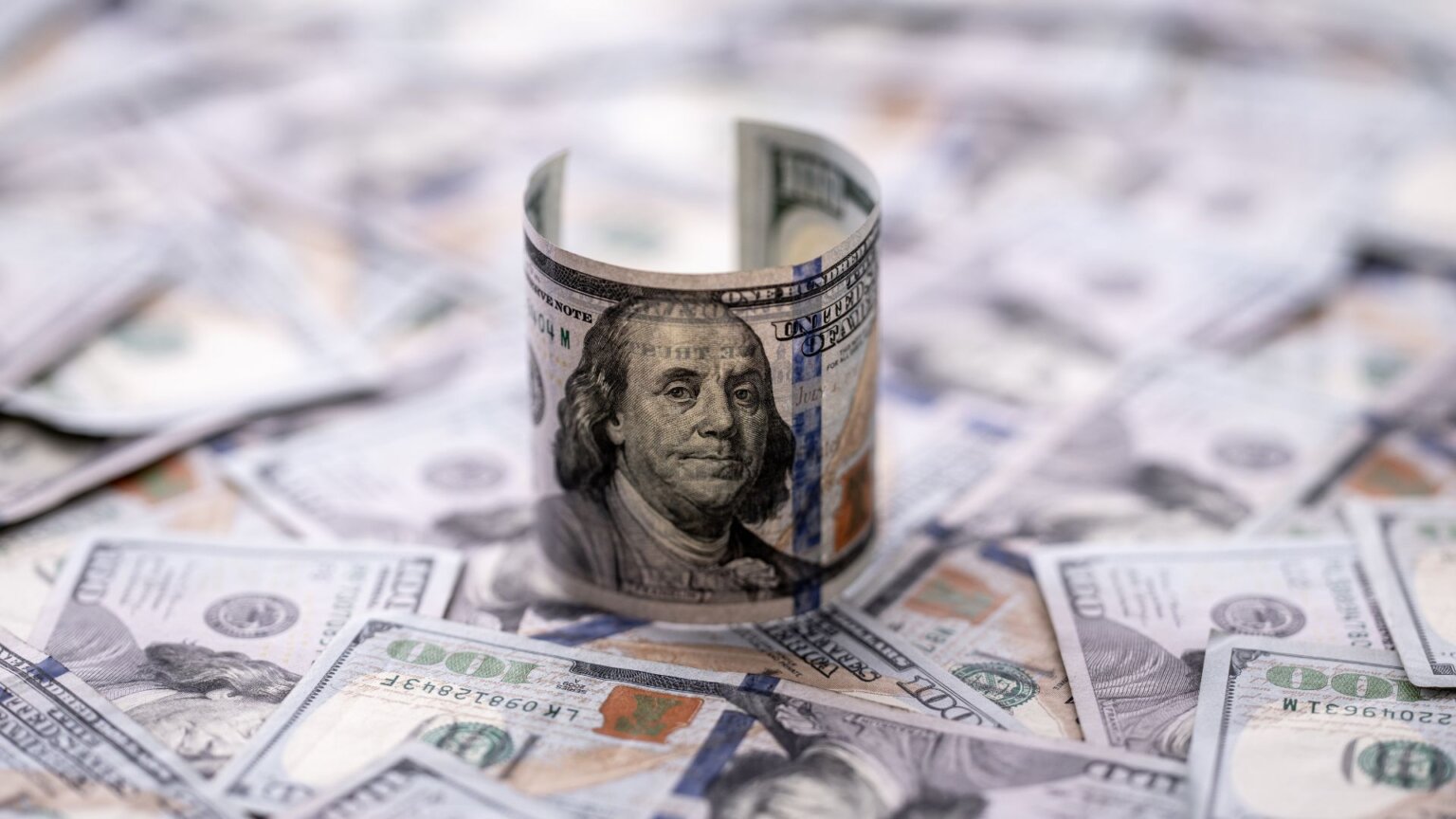 Close-up view of a $100 bill featuring Benjamin Franklin with currency details visible