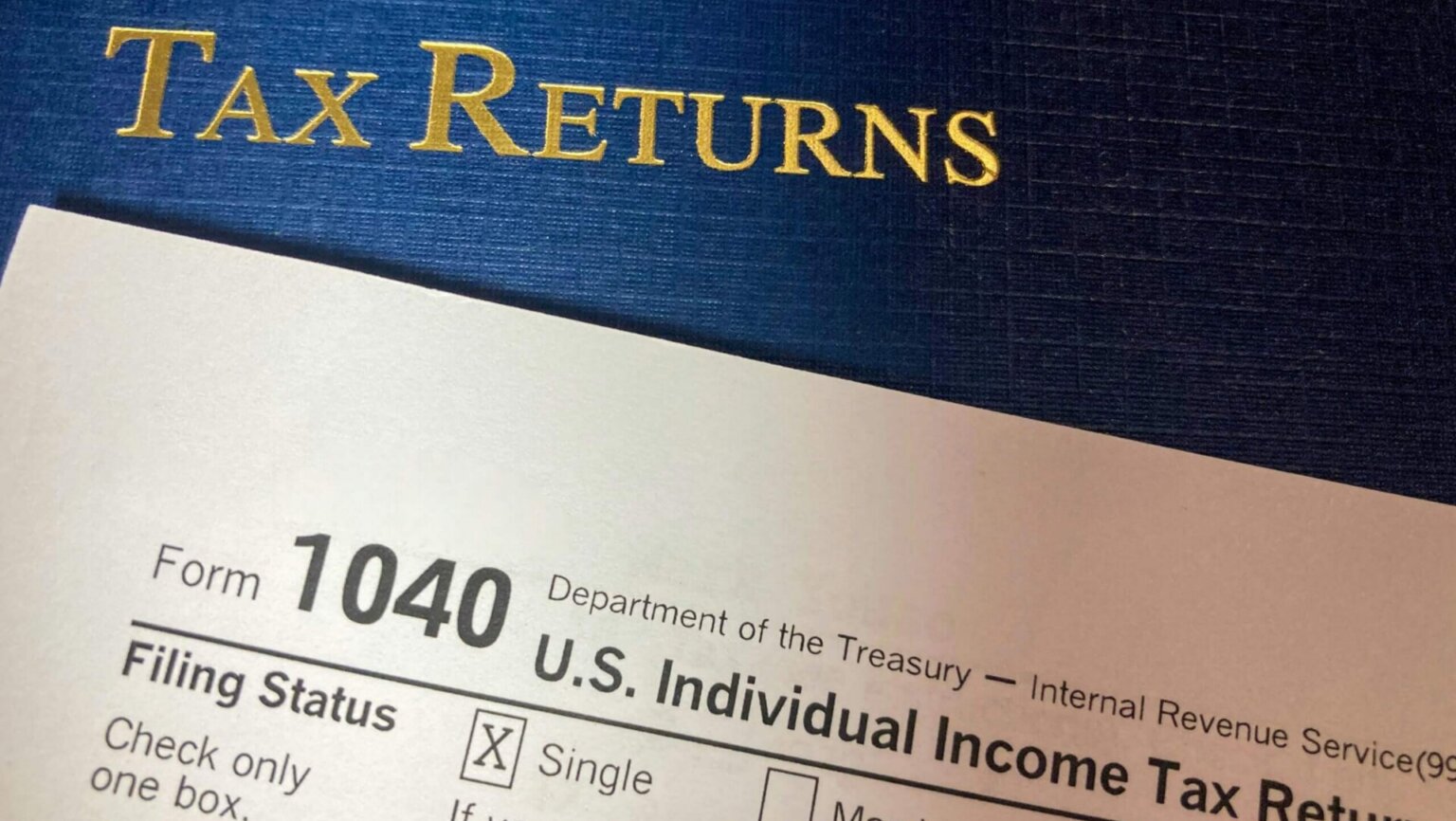 Millions Head Into Tax Season With Changes to Forms and Deadlines This Year Tax return documents and financial paperwork spread across a desk.