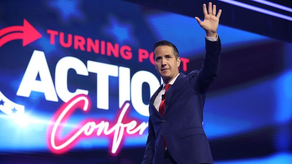 Moreno waving on stage at a Turning Point Action conference.