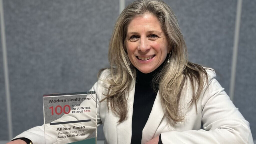 Allison Sesso in a white blazer, holding a Modern Healthcare award for 100 most influential people in 2024.