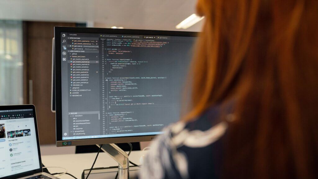 Corporate employee sitting at a desk working on a computer in an office setting