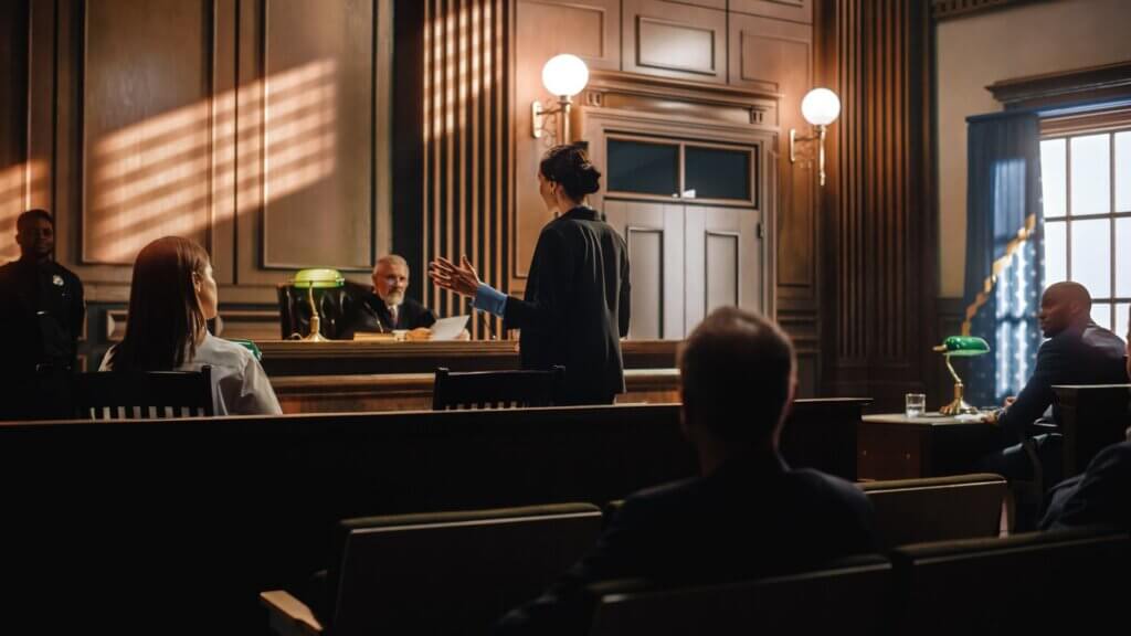 Female attorney standing in a courtroom during a trial hearing