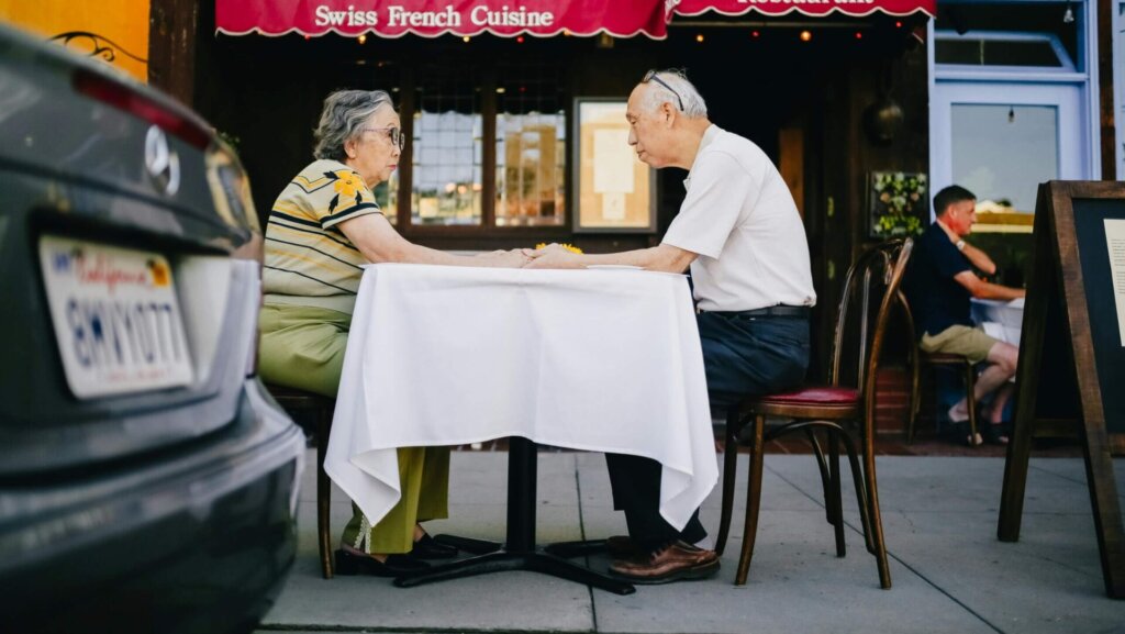 Elderly couple having breakfast together at a restaurant.