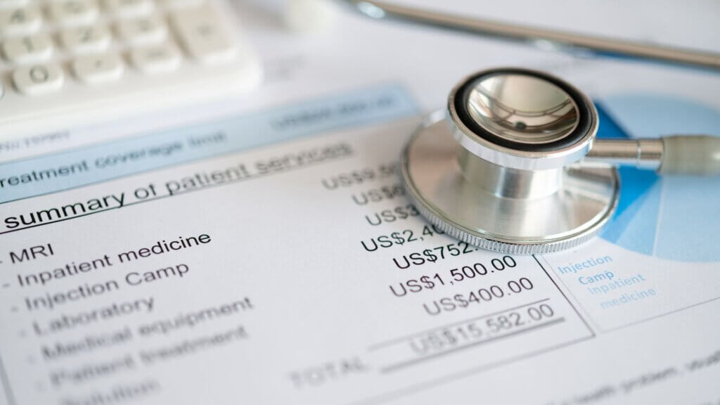 Close-up of a stethoscope on a medical bill listing various healthcare charges.