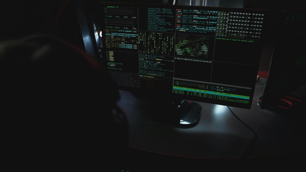 Person using a desktop computer at a workstation, focused on the screen while working or browsing online.