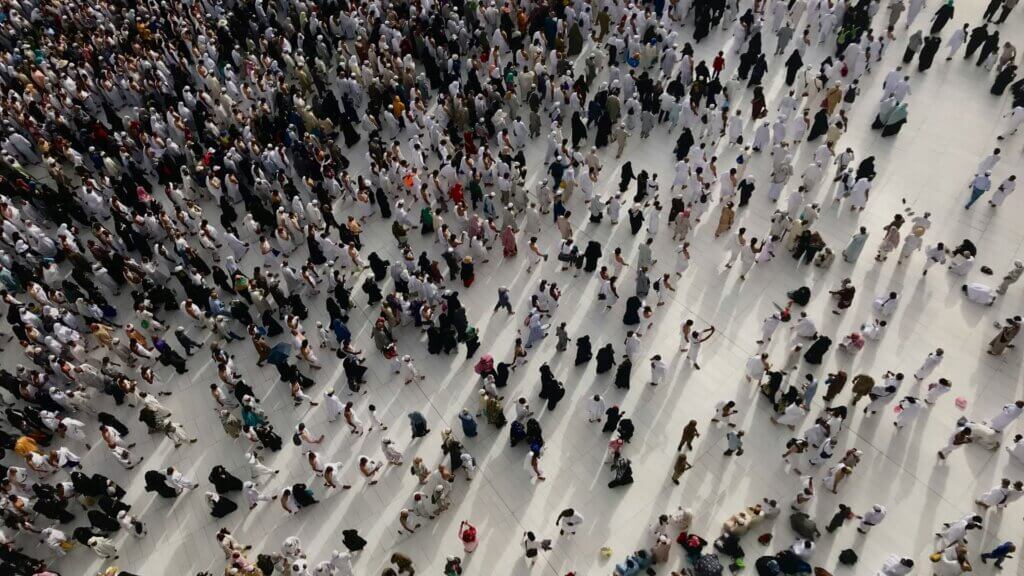 Large group of people gathered indoors in a public space.