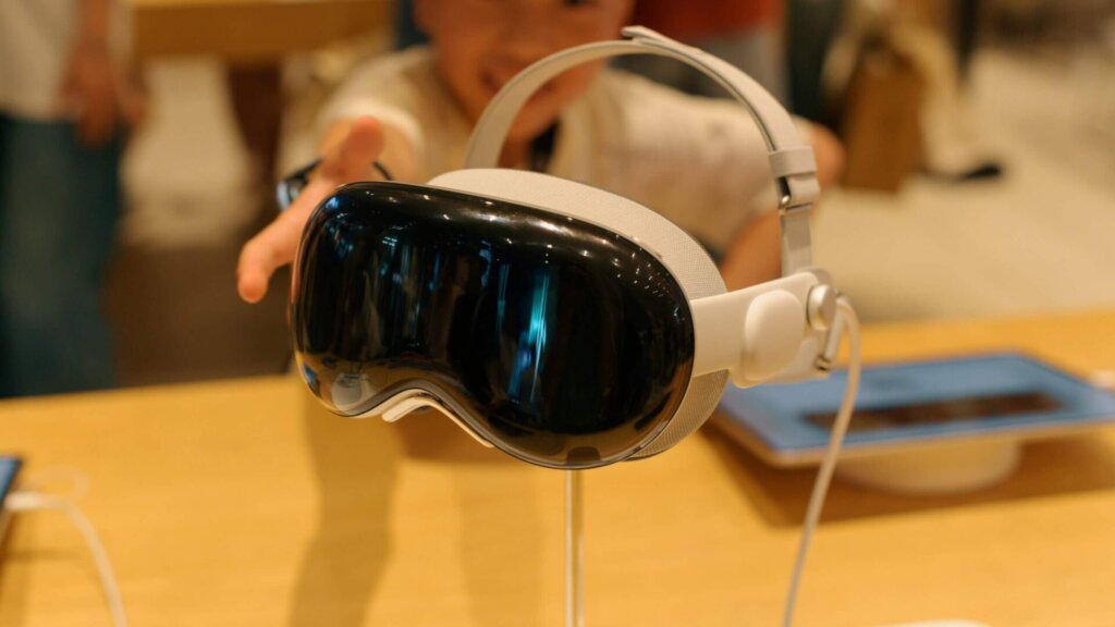 Baby wearing headphones while sitting on a table.