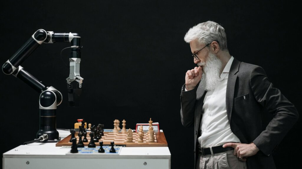 Elderly man deep in thought while looking at a chessboard.