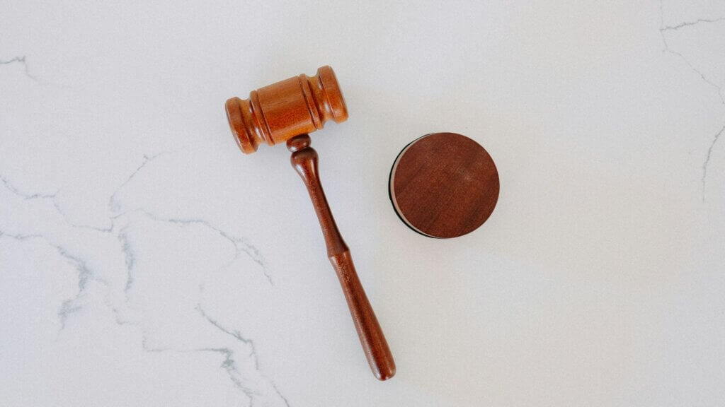 Wooden judge’s gavel placed on a white surface symbolizing a court decision