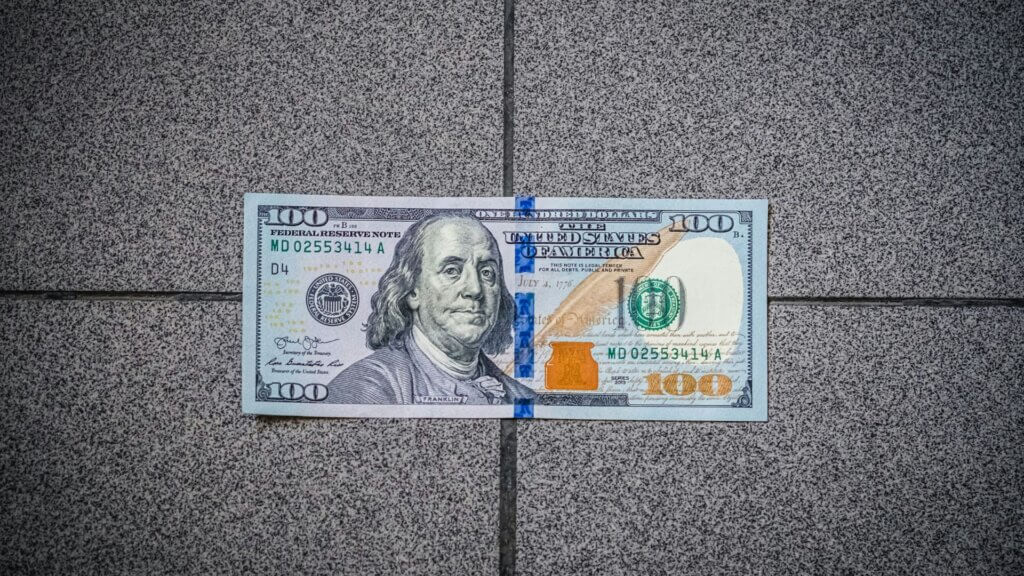 $100 bill showing a star symbol at the end of the serial number