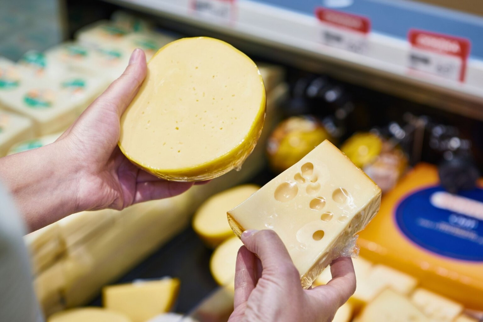 Buyer chooses cheese in store