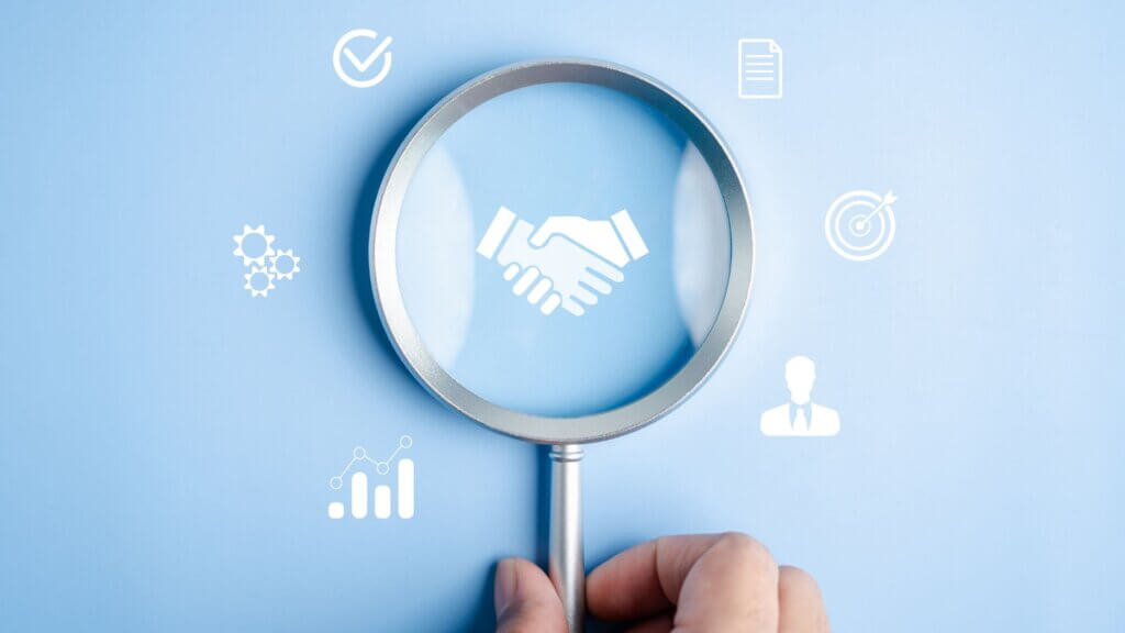 A magnifying glass over digital icons