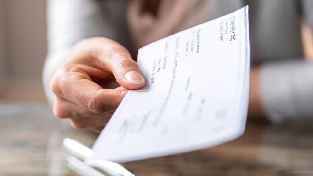 Woman giving a paycheck payment