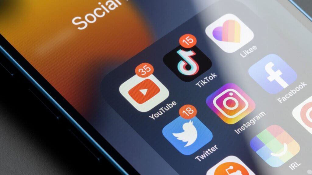 Assorted social media apps are seen on an iPhone