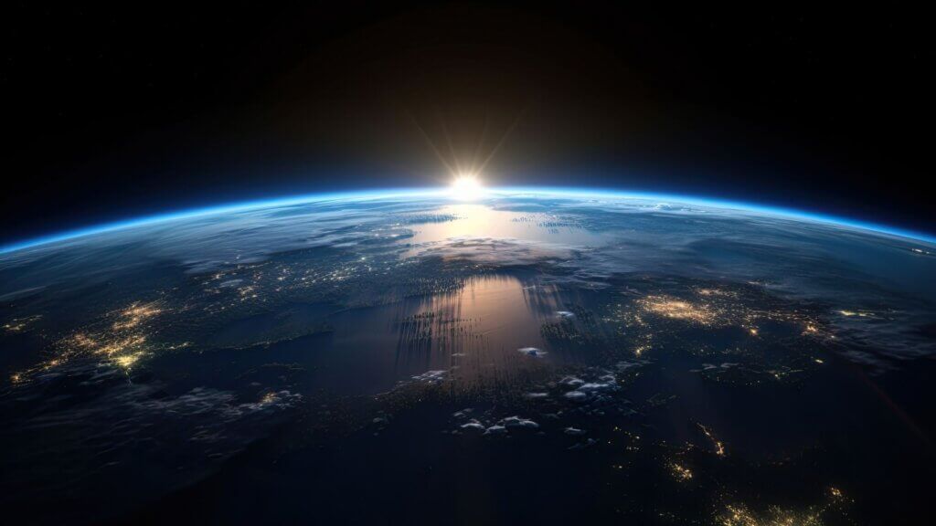 Sunrise view of the planet Earth from space with the sun setting over the horizon