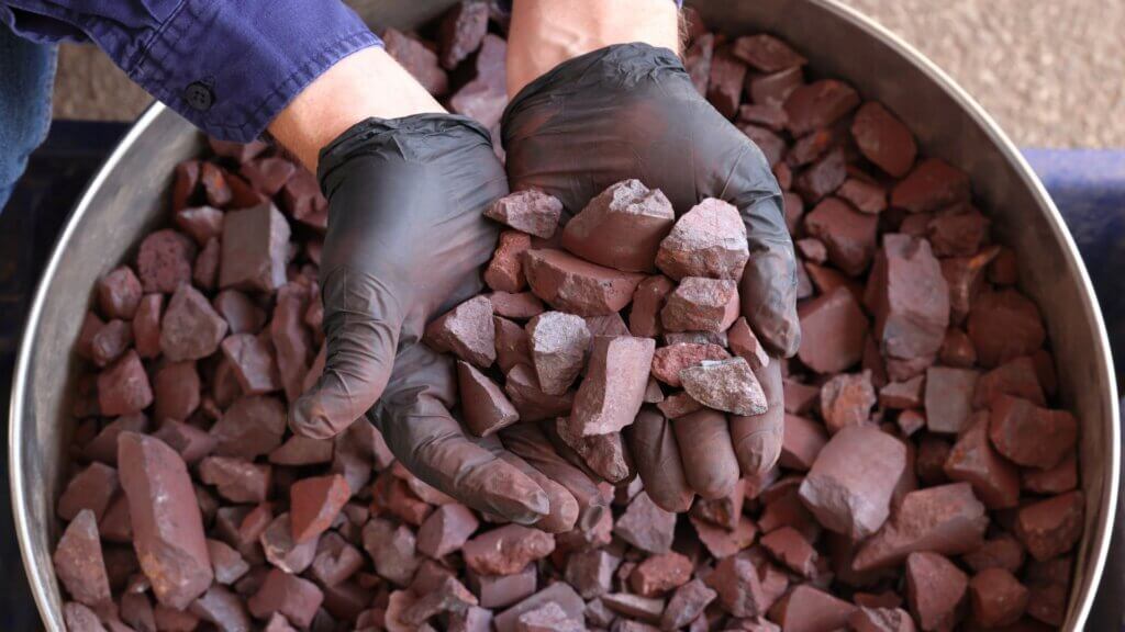 High-grade hematite iron ore from the Pilbara region, Western Australia, held in hand