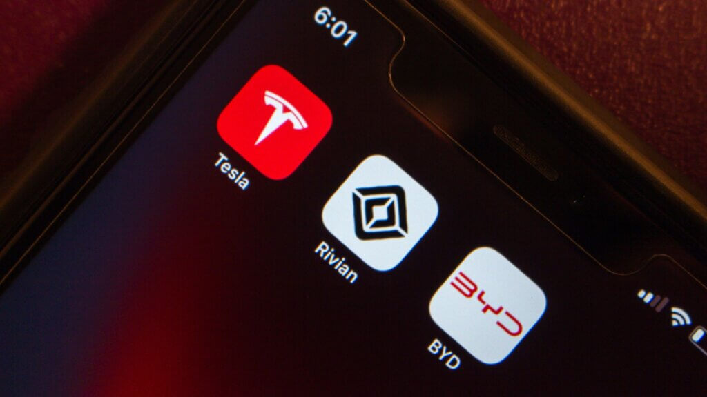 Tesla, Rivian, and BYD apps on cell phone