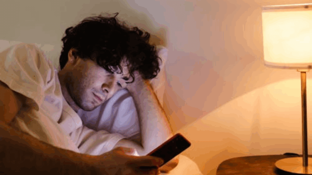 a man using his phone during bedtime