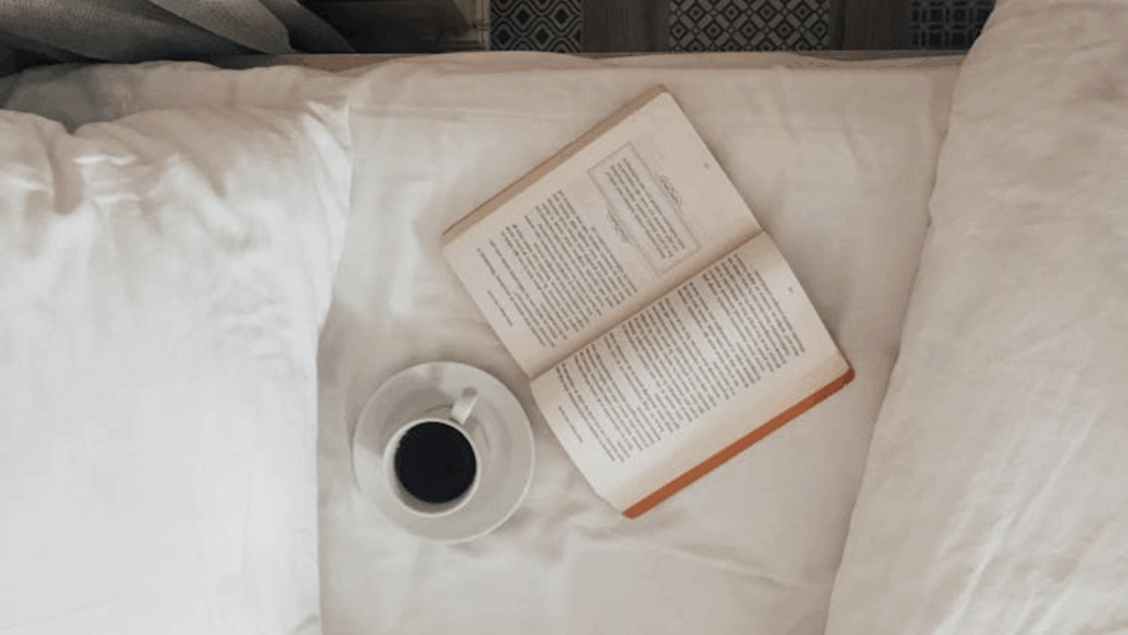 book and coffee by the bed